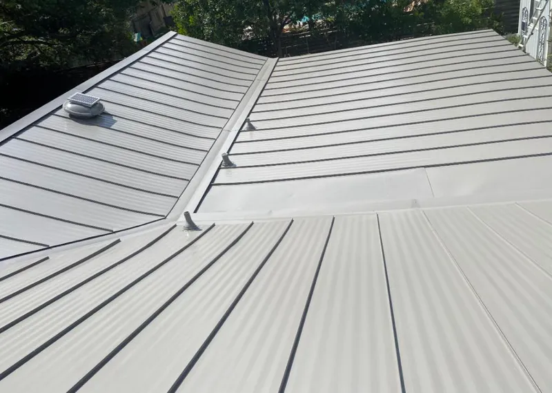 Solar attic fan installed on a metal roof for Roof Ventilation in Brook Highland